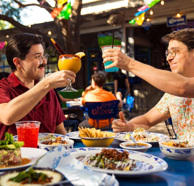 Couple enjoying frozen margaritas and mexican Food