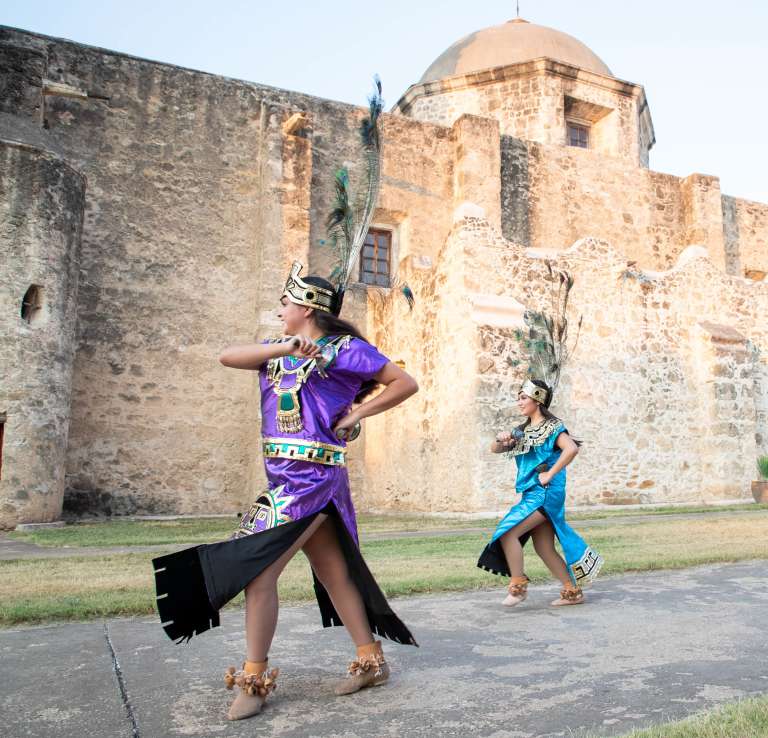 Performer smiling at San Antonio Missions National Historical Park.