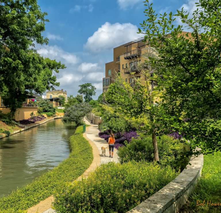 Woman walking dog along Museum Reach of River Walk