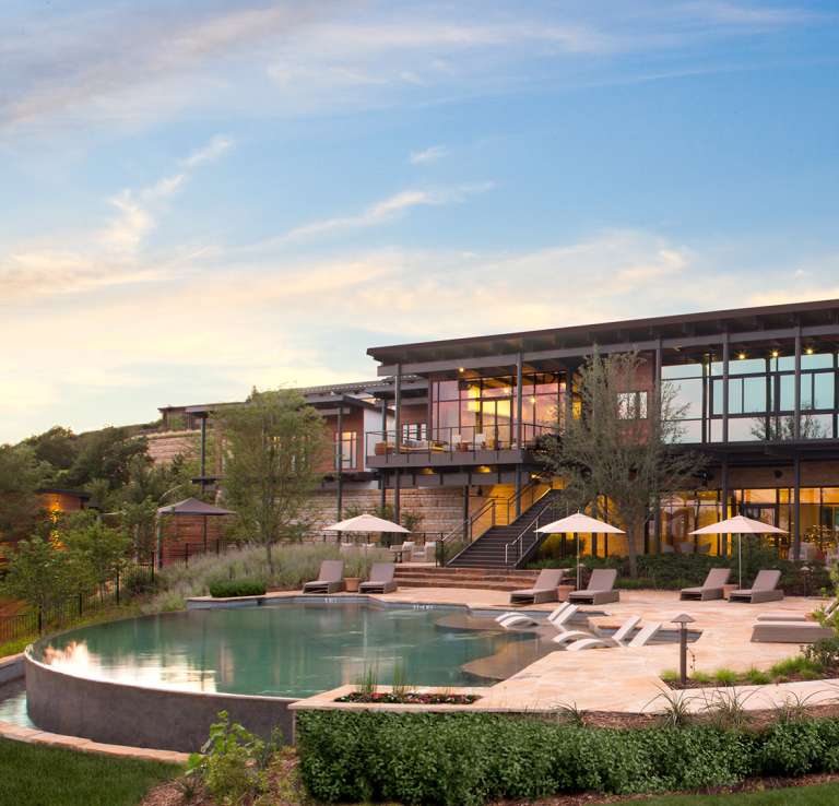 External building overlooking pool with umbrellas