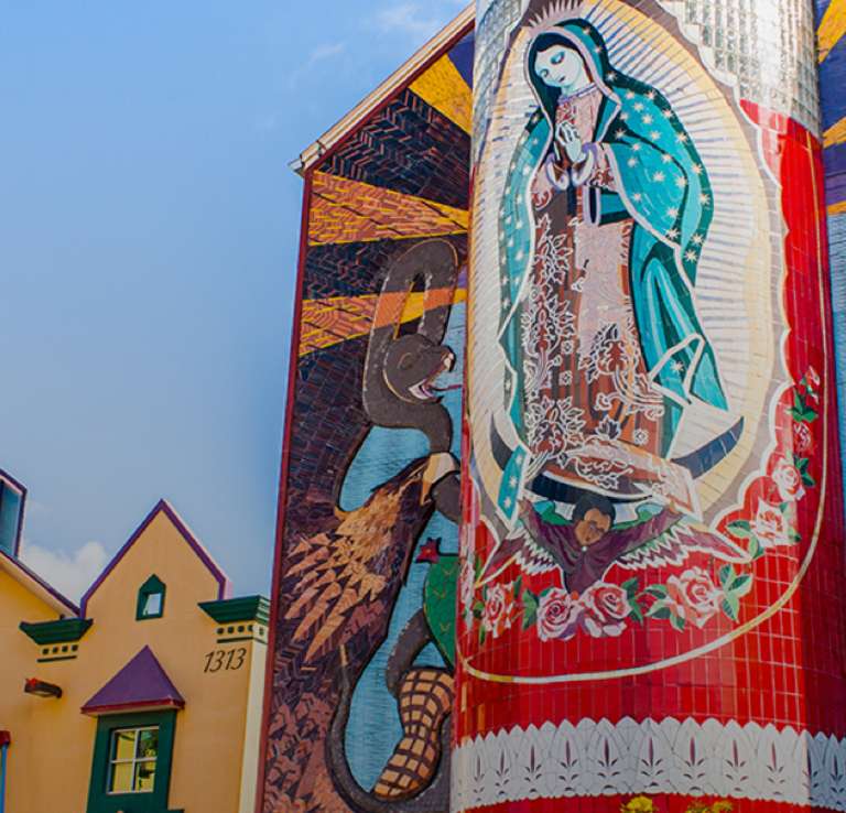 External view of Guadalupe Cultural Arts Center with veladora mural on side of building.