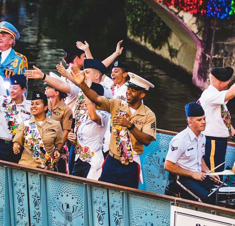 Service men and woman waving on river barge