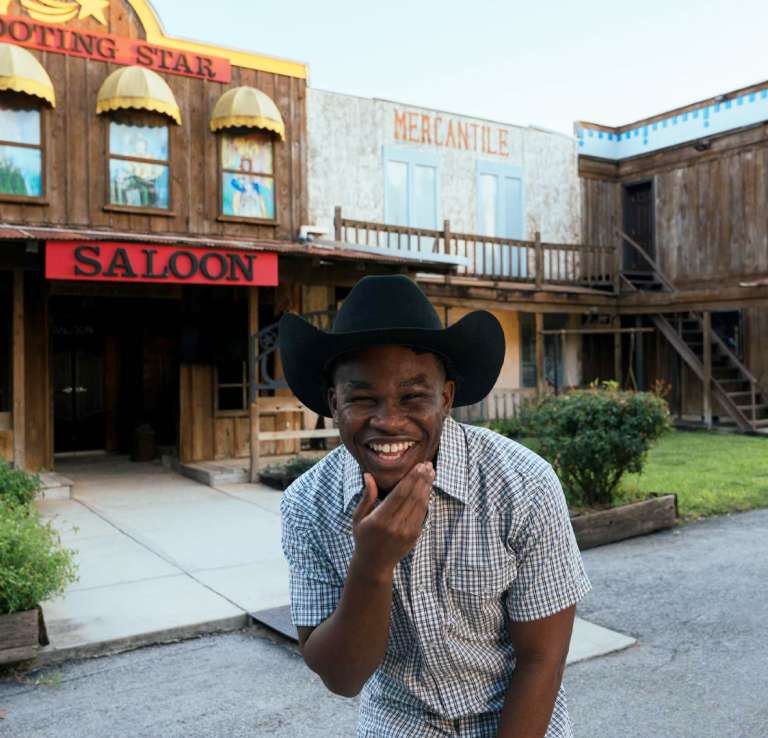 Man smiling in cowboy hat at Pedrotti's Ranch.