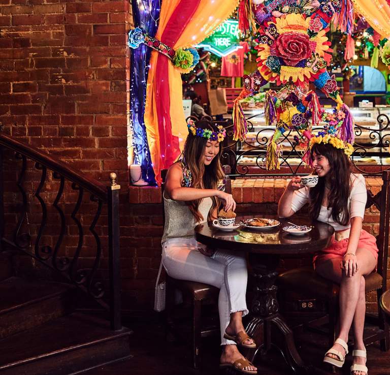 Two girls eating Mexican pastries at Mi Tierra in San Antonio.