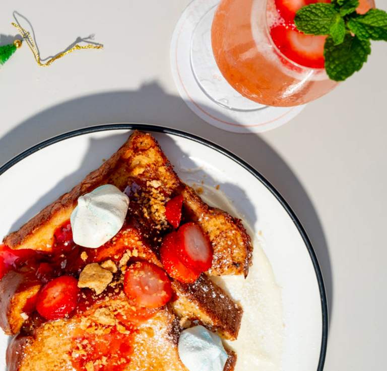 Overhead view of french toast meal with donut