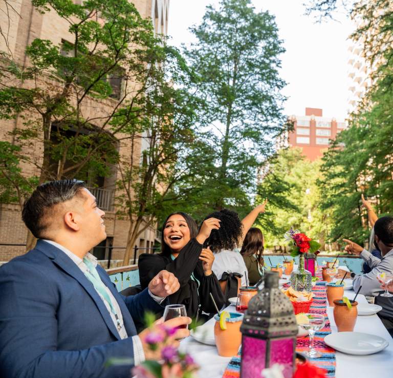 Group enjoying dinner on a river barge on the River Walk.