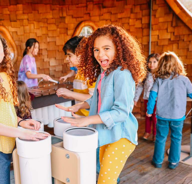 Two girls laughing and playing at the DoSeum