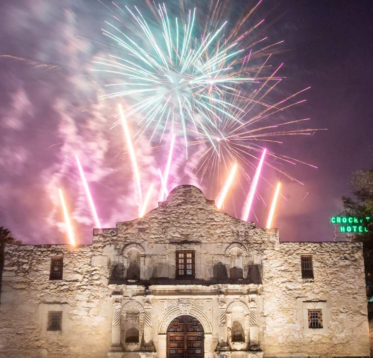 Fireworks going off behind the Alamo.