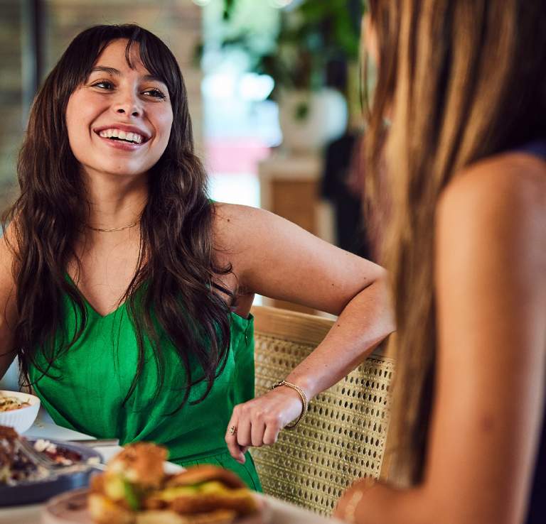 Woman laughing with food on fork