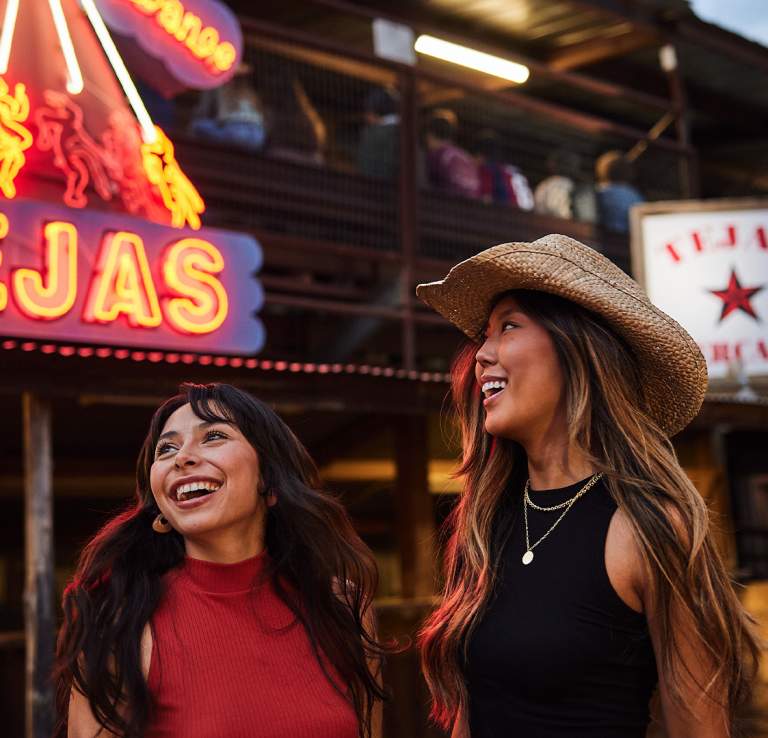 Two girls laughing at Tejas Rodeo in San Antonio