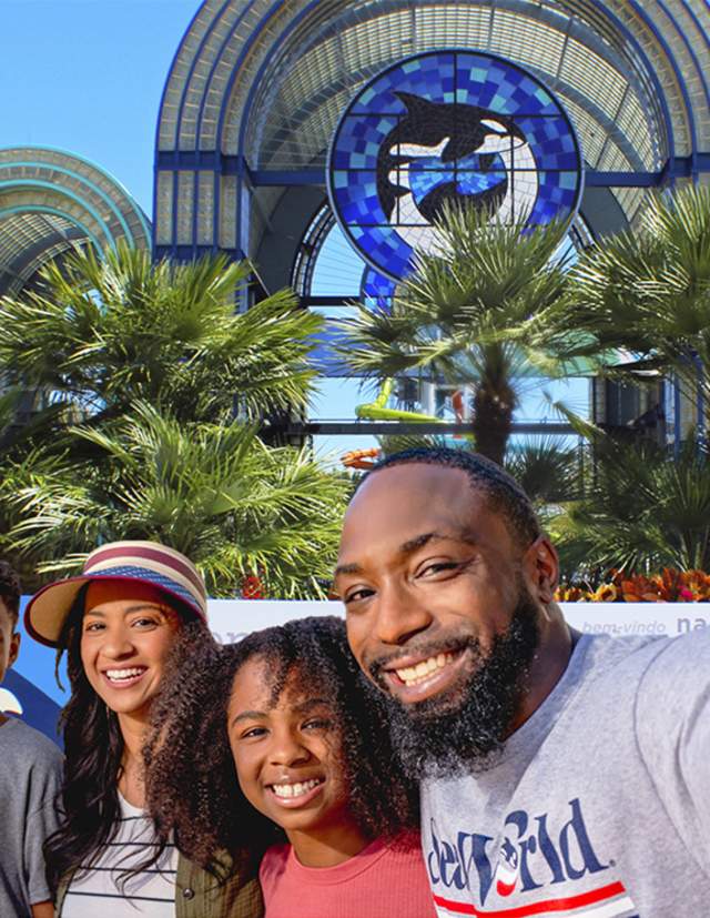Family taking selfie in front of SeaWorld San Antonio arches