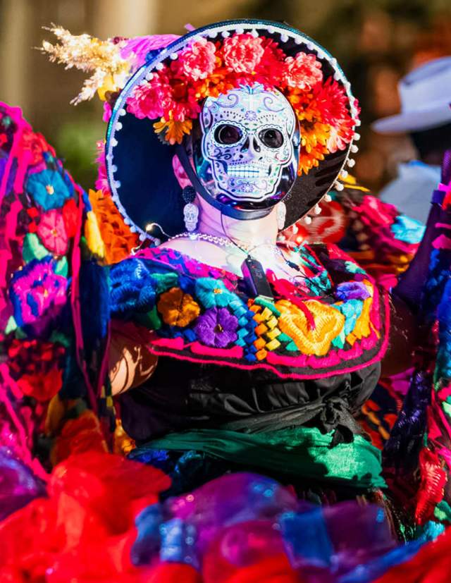 Performer in sugar skull mask at Day of the Dead event in San Antonio.