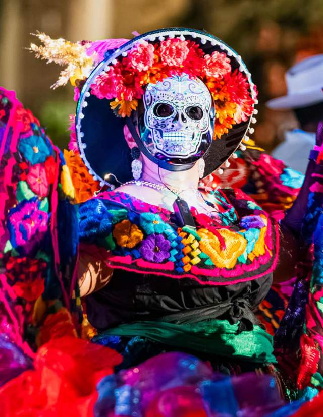 Performer in sugar skull mask at Day of the Dead event in San Antonio.