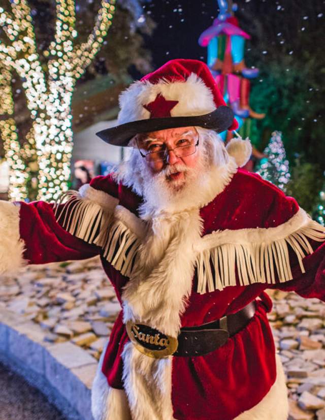 Santa in front of holiday outdoor decorations at SeaWorld San Antonio.