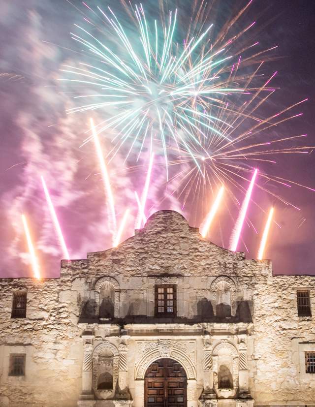 Fireworks going off behind the Alamo.