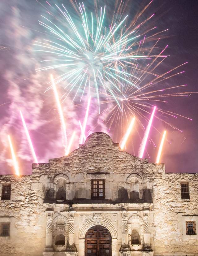 Fireworks going off behind the Alamo.