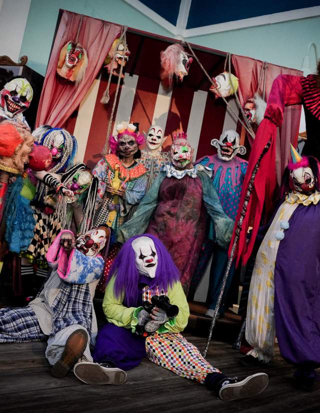 Row of clowns in haunted house at Six Flags Fiesta Texas Fright Fest.