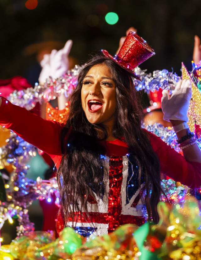 Participants waving from river barge with holiday decorations