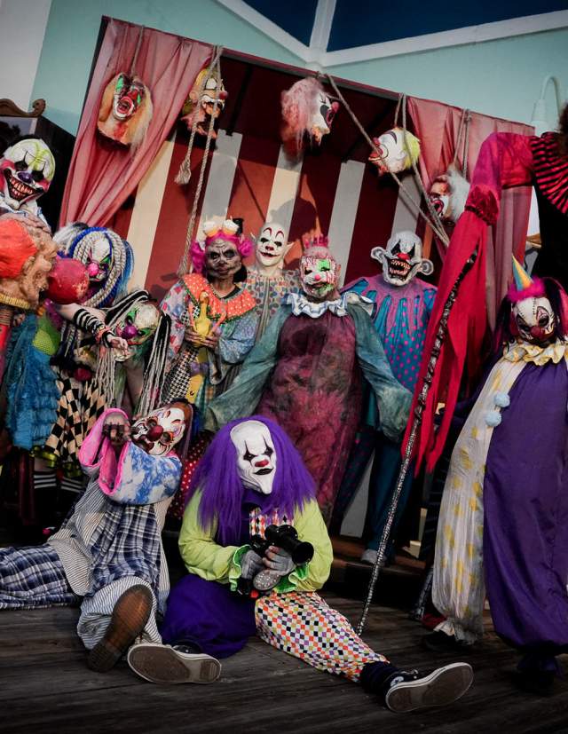 Row of clowns in haunted house at Six Flags Fiesta Texas Fright Fest.