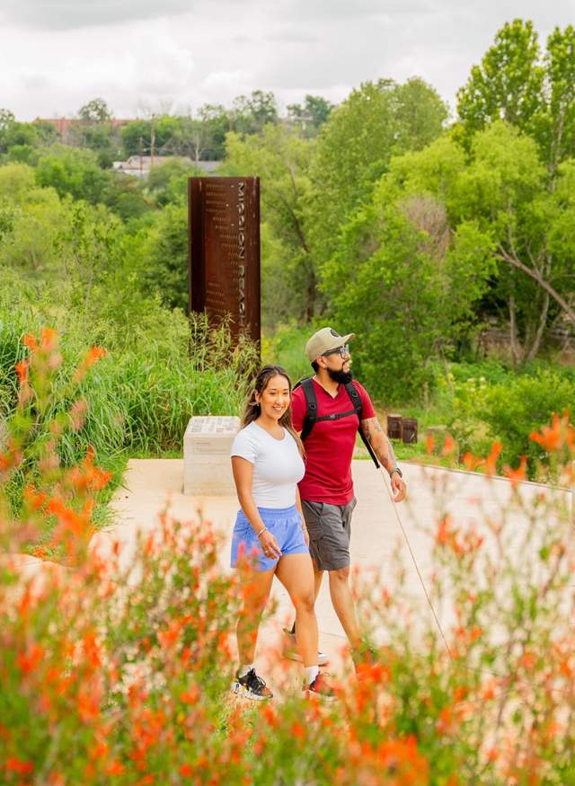 people walking in lush greenery