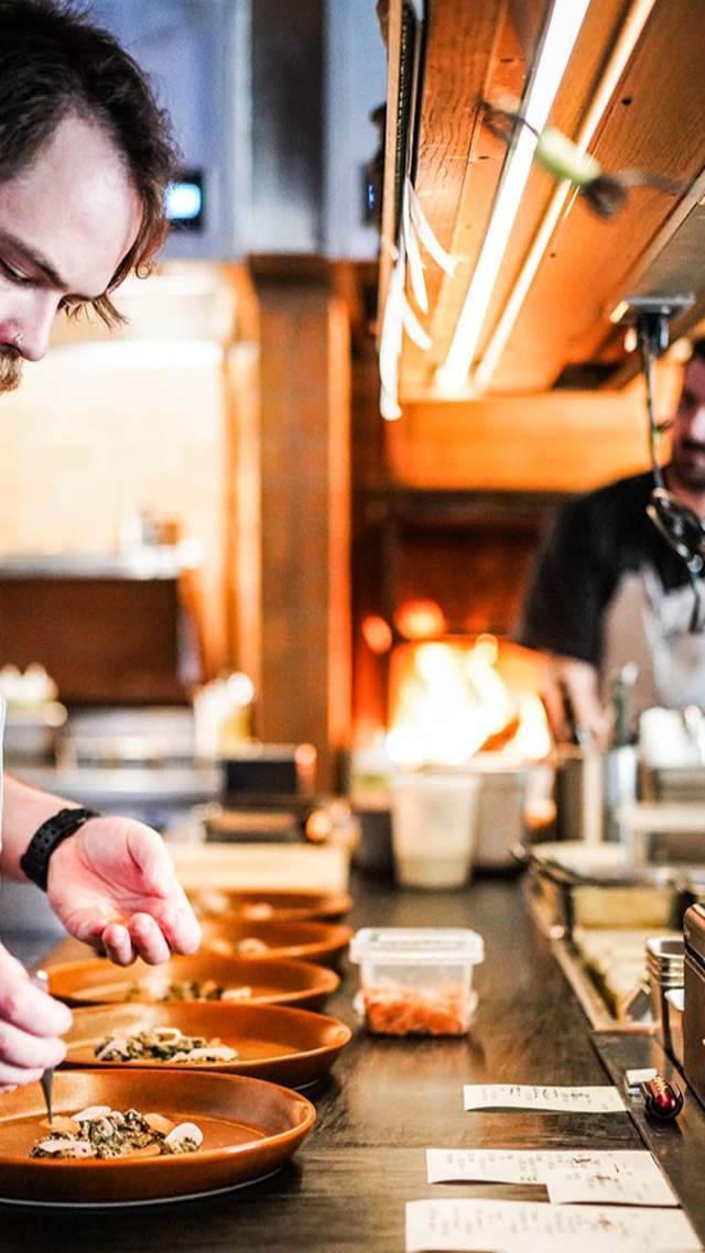 Isidore Chef de Cuisine Ian Lanphear preparing dish