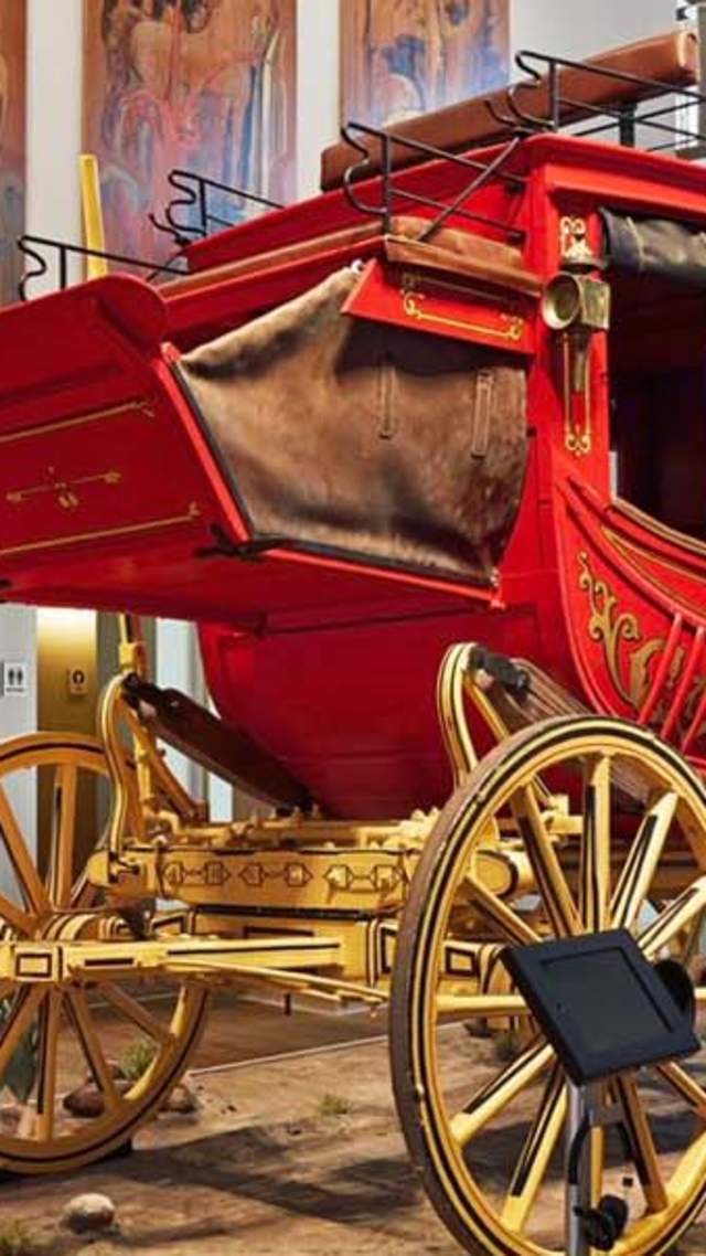 Red covered wagon inside musem exhibit