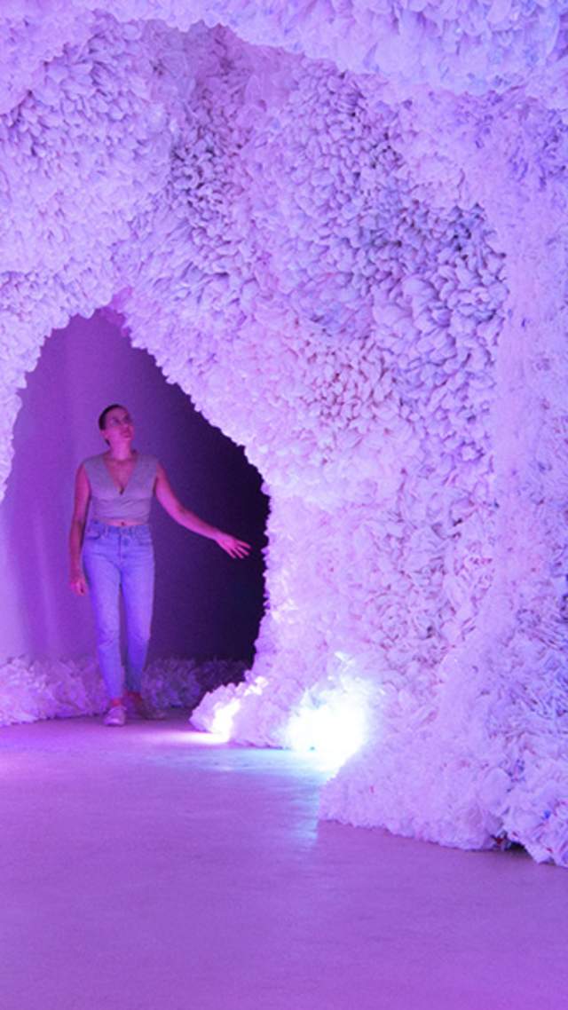 Woman in colorful cave of art