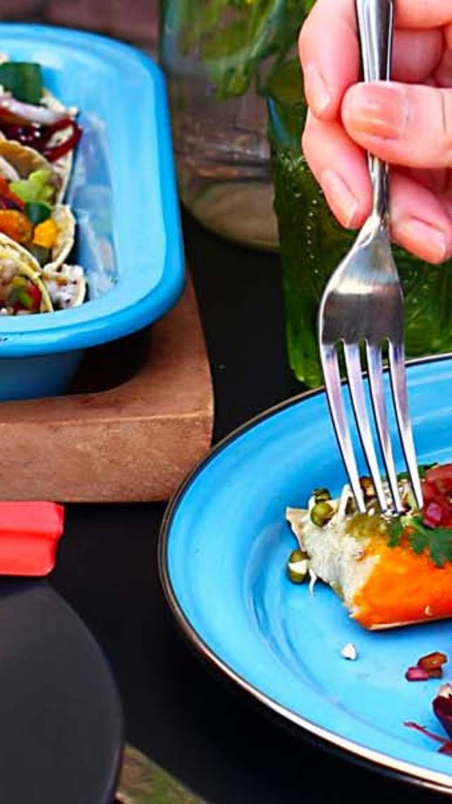 spread of three different plates from the side view with a hand holding a fork