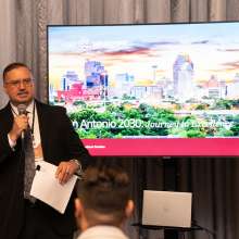 Man speaking in front of presentation