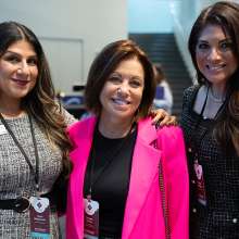 3 women professionals at conference