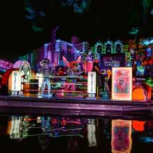 River parade at night with Dia de los Muertos decor