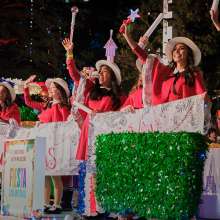 Girls dressed as book character Madeline waving with wands