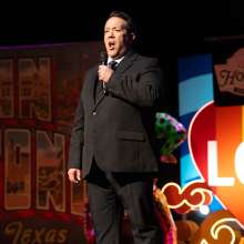 Man singing opera onstage.