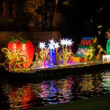 Illuminated chili peppers on river barge