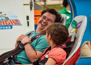 boy and girl getting ready to go on theme park ride