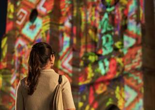 Woman looking at San Antonio | The Saga show at San Fernando Cathedral.