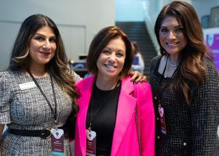 3 women professionals at conference