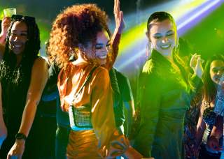 Clubgoers dancing inside nightclub