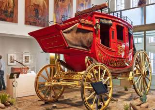 Red covered wagon inside musem exhibit