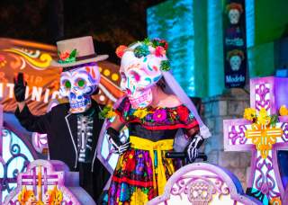 female and male skeleton characters at the Day of the Dead San Antonio River Parade