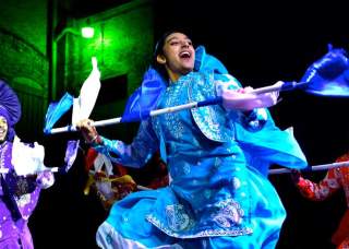 Costumed performers at DiwaliSA with multicolored performance pieces.