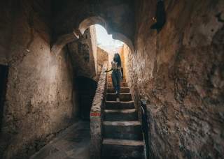 Woman walking down stairs at San Antonio Missions National Historical Park.