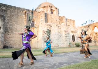 Performer smiling at San Antonio Missions National Historical Park.