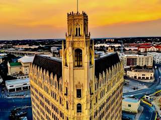 Overhead view of Emily Morgan Hotel in San Antonio with skyline in the background.