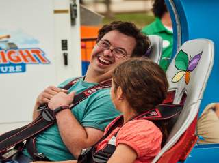 boy and girl getting ready to go on theme park ride