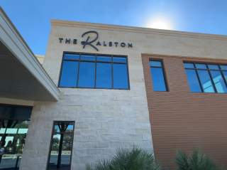 Exterior view of The Ralston venue with sunlight in background at San Antonio Zoo.