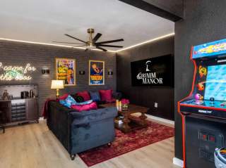 Vacation rental with Pac-Man game and living room in background.