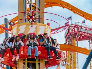 People on Shazam-themed drop tower ride at Six Flags Fiesta Texas.