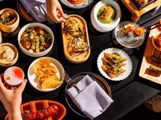Overhead view of spread of food at Tenfold bar at Kimpton Santo in San Antonio.