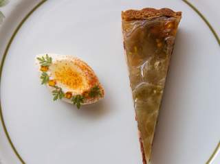 Overhead view of plate with apple pie and decorated deviled egg.